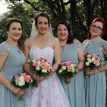 Hannah after Bell's palsy recovery at her wedding with bridesmaids